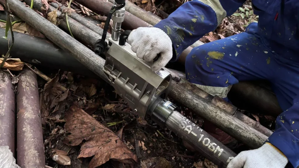 Technician swaging a LOKRING fitting onto a small-bore pipe